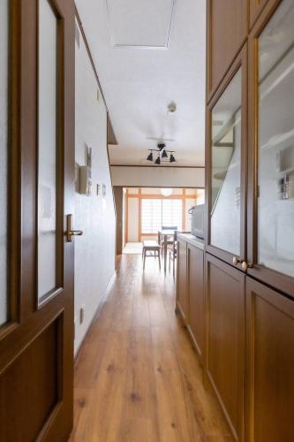 a hallway with a dining room with a table at Nakamichi House 中道戸建 in Osaka