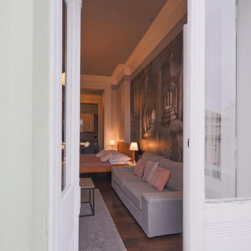 a living room with a couch and a bed at Janackovo - Riverside Residence in Prague