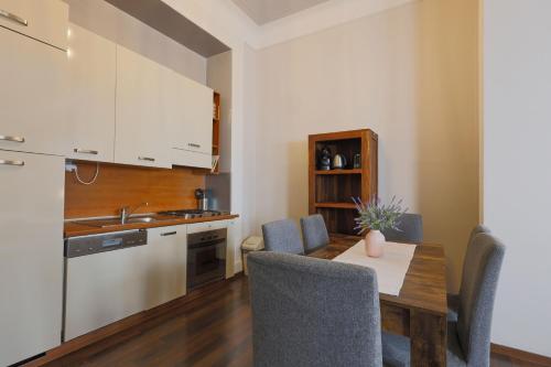 a kitchen and dining room with a table and chairs at Janackovo - Riverside Residence in Prague