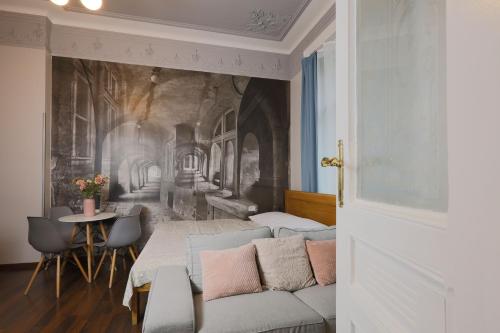 a living room with a couch and a table at Janackovo - Riverside Residence in Prague