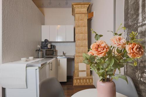 a kitchen with a vase with flowers on a table at Janackovo - Riverside Residence in Prague