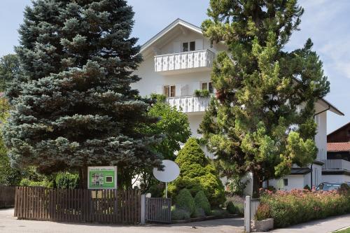 a white building with trees in front of it at Haus Sibylle in Bad Tölz