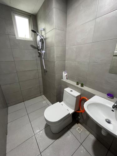 a bathroom with a toilet and a sink at Humaira - Metropol in Bukit Mertajam
