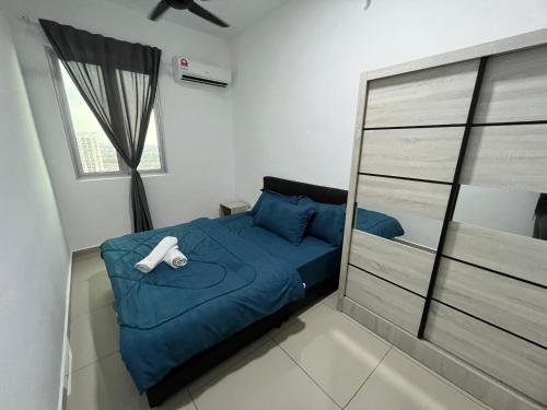 a bedroom with a blue bed and a window at Humaira - Metropol in Bukit Mertajam