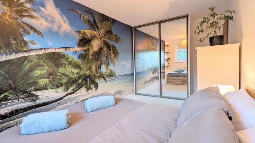 a bedroom with a palm tree mural on the wall at Ranmoor Garden View Apartment in Sheffield