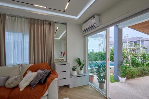 a living room with a couch and a mirror at Phuket Paradise Retreat in Phuket