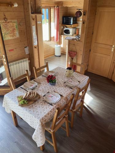 a table in a cabin with a table cloth on it at La Marmotte in Chorges