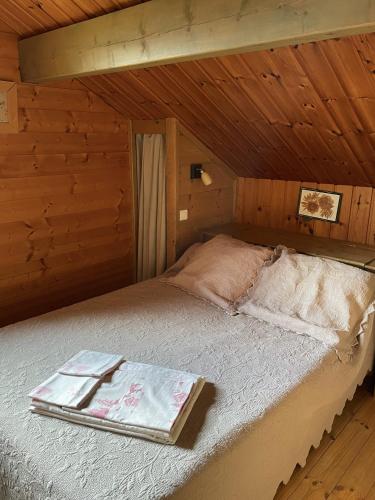 a bed in a wooden cabin with a tray on it at La Marmotte in Chorges