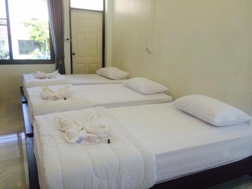 a group of four beds in a room at LayTrang Pakmeng Marina Spa and Resort in Trang