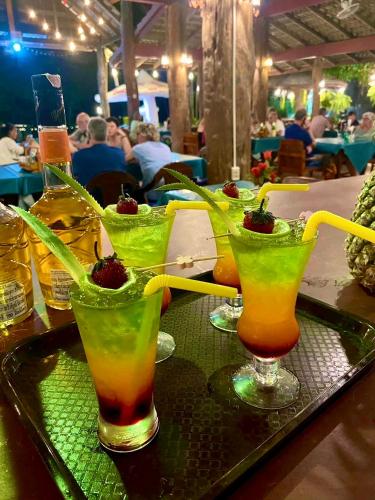 three cocktails sitting on a tray on a table at Happy Lagoon Bungalow in Khao Lak