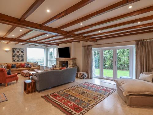a living room with a couch and a fireplace at Blossom Hill in Witney
