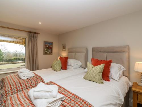 two beds sitting next to each other in a bedroom at Blossom Hill in Witney