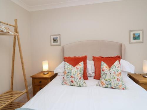 a bedroom with a white bed with pillows at Blossom Hill in Witney