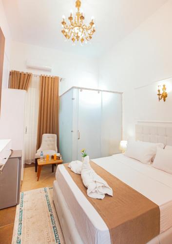 a bedroom with a large bed and a chandelier at Downtown Antique Hotel in Cairo