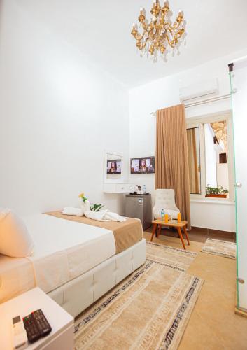 a bedroom with a large bed and a chandelier at Downtown Antique Hotel in Cairo