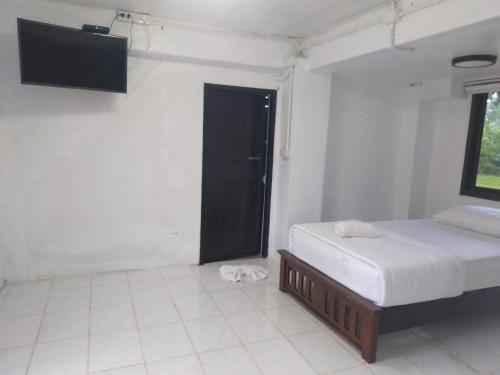 a room with two beds and a television in it at LayTrang Pakmeng Marina Spa and Resort in Trang