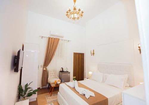 a bedroom with a bed and a chandelier at Downtown Antique Hotel in Cairo