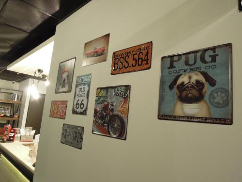 a wall with posters and signs on it at Re-Change Hotel Taipei in Taipei