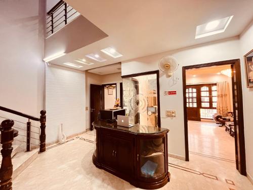 a room with a desk with a laptop on it at South Inn - Green Park South Delhi in New Delhi
