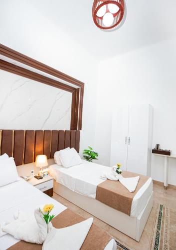 a bedroom with two beds and a mirror at Downtown Antique Hotel in Cairo