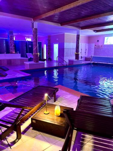 a large swimming pool with a candle in the middle at Re Sole Resort&Spa in Grottaglie