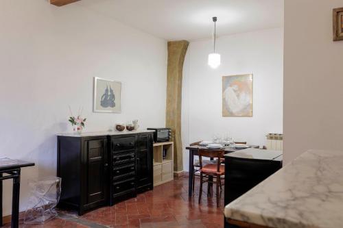 una cucina con tavolo e mobile nero di Toscanella Comfort Apartment a Firenze