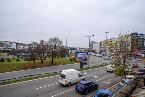 a city street with cars parked on the road at Top Central 6 Apartments in Belgrade