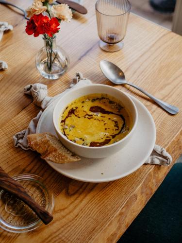 a bowl of soup on a wooden table at Botanico Finkenrech Hotel&Restaurant in Eppelborn