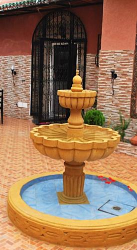 a fountain in the middle of a courtyard at Villa Dar Lghzal Summer Promo Airport Pick-Up & Private Dining in Heart of Rabat in Rabat