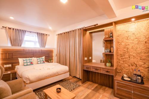a bedroom with a bed and a couch at Flock Kathmandu in Kathmandu