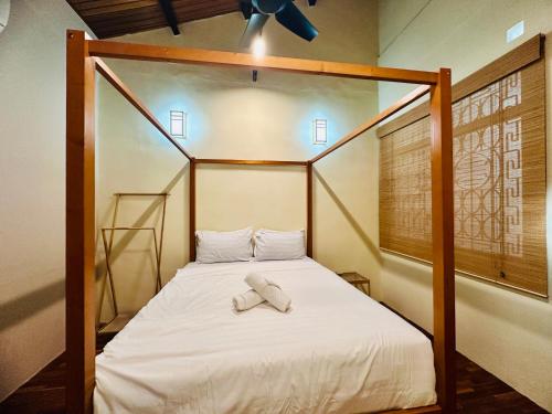 a bedroom with a bed with two towels on it at New Takekaze Retreat 竹风之家 for 14 pax at Central Penang in George Town