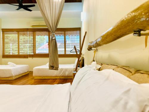a bedroom with two beds and a window at New Takekaze Retreat 竹风之家 for 14 pax at Central Penang in George Town