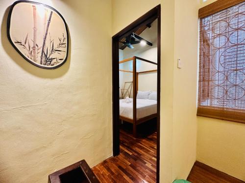 a mirror on the wall of a room with a bedroom at New Takekaze Retreat 竹风之家 for 14 pax at Central Penang in George Town