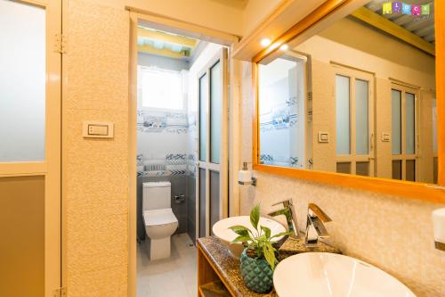 a bathroom with two sinks and a toilet at Flock Kathmandu in Kathmandu