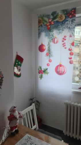 a dining room with christmas decorations on the wall at Apartman Zlatovo Stan Na Dan in Požarevac