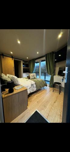 a bedroom with a bed and a desk in it at Waters edge Pontypridd in Treforest