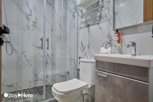 a bathroom with a toilet and a sink and a shower at StayHere Casablanca - Oasis - Premium Residence in Casablanca