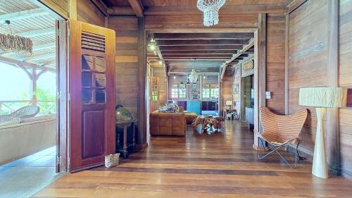 a hallway with wood paneled walls and a living room at Villa Scarlett, luxueuse villa vue mer 5 étoiles in Trois-Rivières