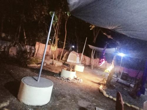 a man standing in front of a fire pit at night at JUNGLE GYM LA UNION Prana fan kubo 2 pax in Rimus