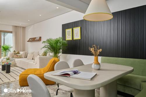 a living room with a table and a couch at StayHere Casablanca - Oasis - Premium Residence in Casablanca