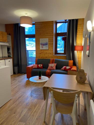un salon avec un canapé et une table dans l'établissement Chamrousse Residence le Balcon de Recoin - Au pied des pistes, à Chamrousse