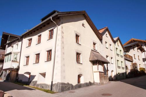 a large white building with a brown roof at Traum in Nauders