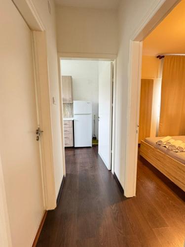 an empty room with a refrigerator and a bedroom at Magic Sea Apartments in Larnaka