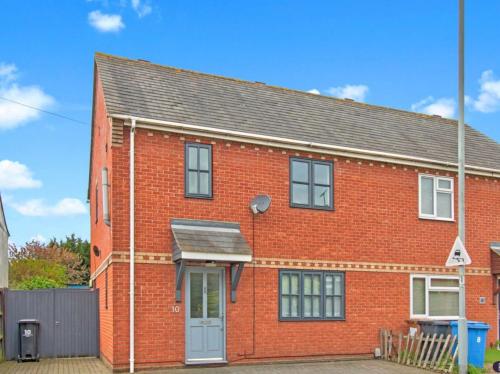 a red brick house with a gray roof at Conveniently located 3 bed spacious home for couples, families and groups in Ipswich in Ipswich