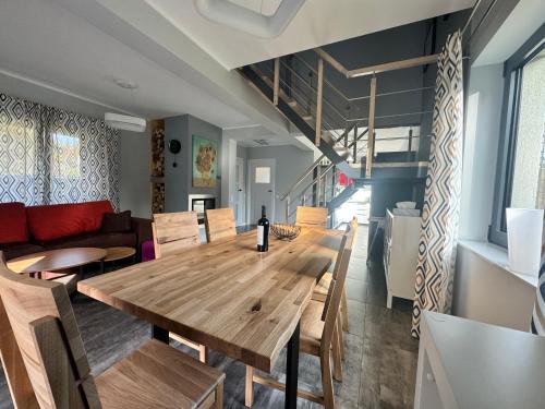 a dining room with a wooden table and chairs at Dom na Mlaskawce in Istebna