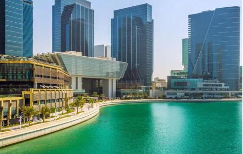 a large body of water in front of a city at Jaunty Stay Abu Dhabi in Abu Dhabi