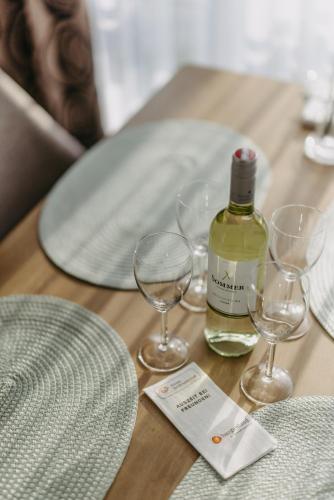 a table with two glasses and a bottle of wine at Große Ferienwohnung Burgenland in Eisenstadt