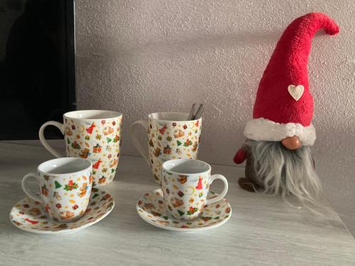 a santa claus hat sitting next to three coffee cups at Da Mattia in Comacchio