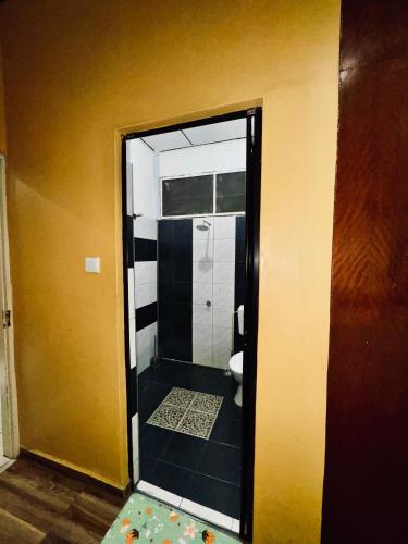 a bathroom with a shower with a toilet in it at Norvilla Homestay A in Pantai Cenang