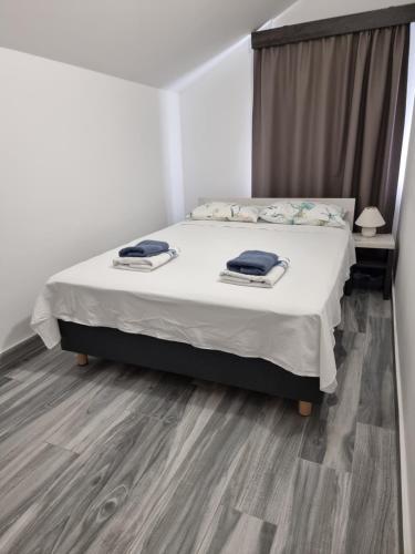a bedroom with a bed with two towels on it at VILLA LAURA in Grebaštica